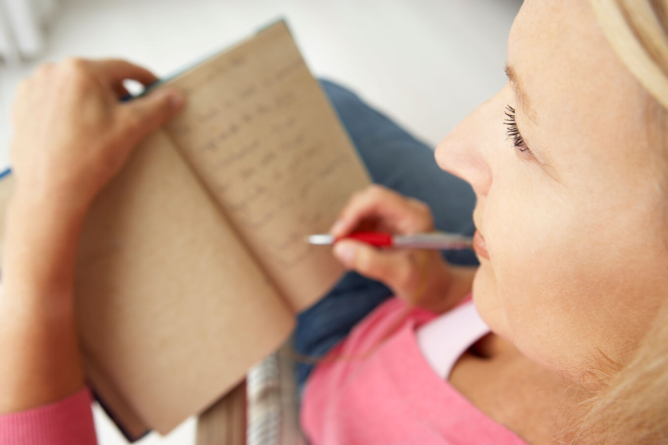 Senior woman writing in notebook